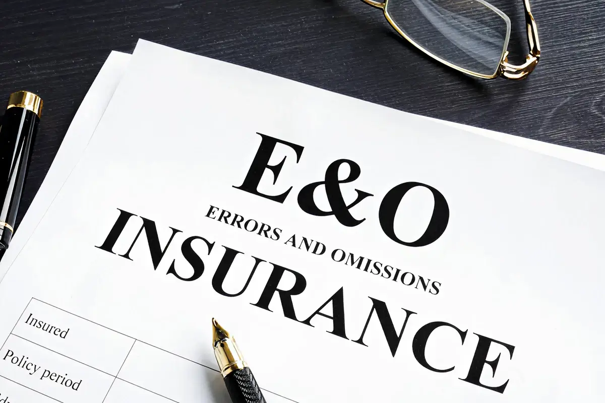 Business professional comparing Errors and Omissions insurance policies, evaluating coverage options beyond price and premiums